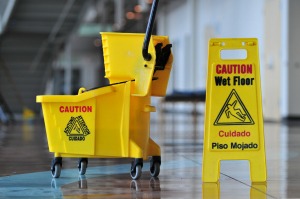 Cleaning bucket and beware sign