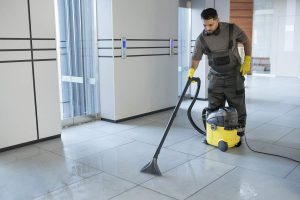 Man vacuuming office floor